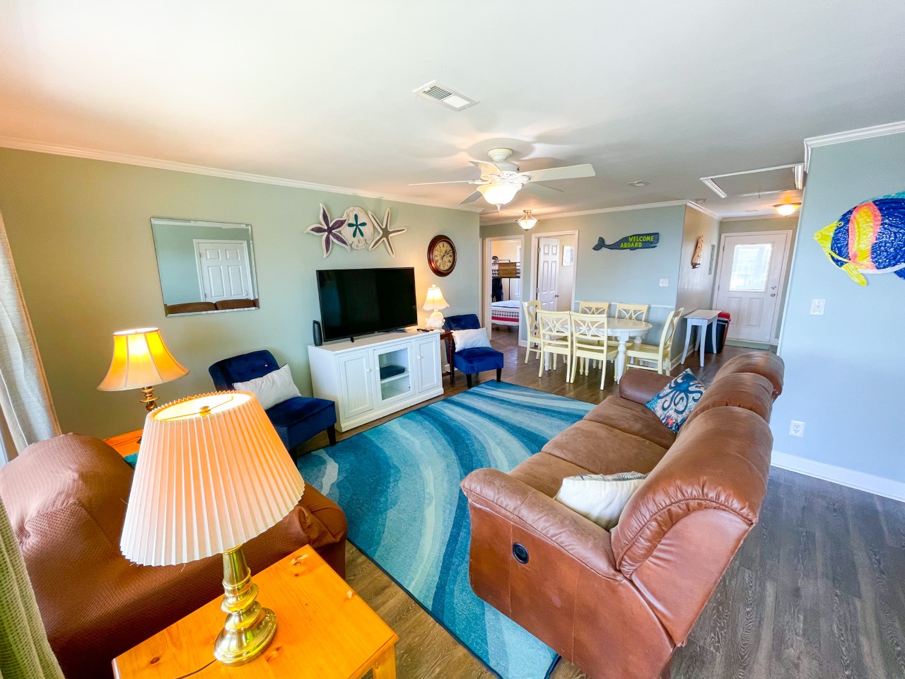 Your ocean-themed living space combines comfort with coastal charm, featuring plush leather seating and cheerful dining for memorable vacation moments.