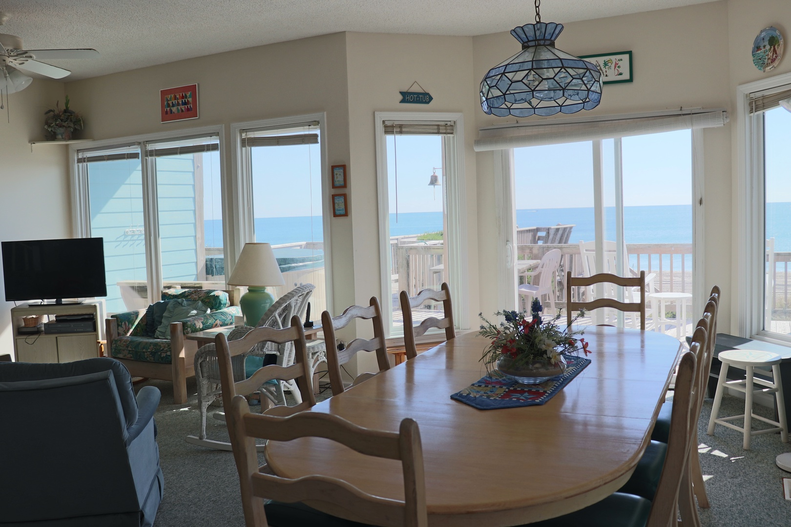 Gather around the spacious dining table with stunning ocean views streaming through every window—your perfect spot for memorable meals.
