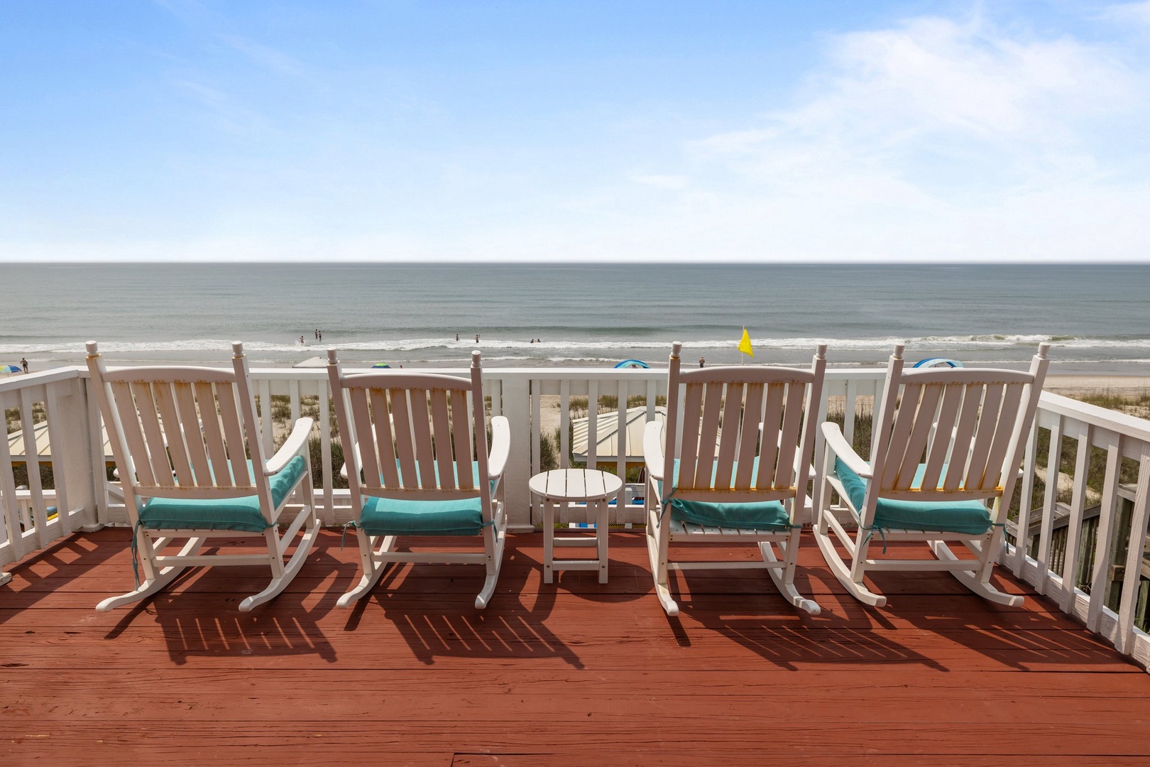 Spacious oceanfront deck with comfortable rocking chairs where you can watch waves roll in and feel the sea breeze.