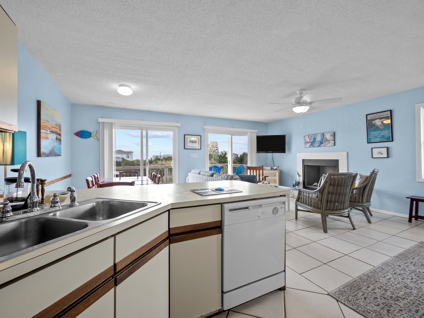 Your coastal kitchen opens to a bright living space where ocean breezes flow through large windows onto comfortable seating.