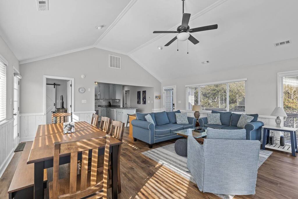Sunlight streams through large windows, warming your spacious open-concept retreat where you'll gather around the dining table and unwind on plush seating.