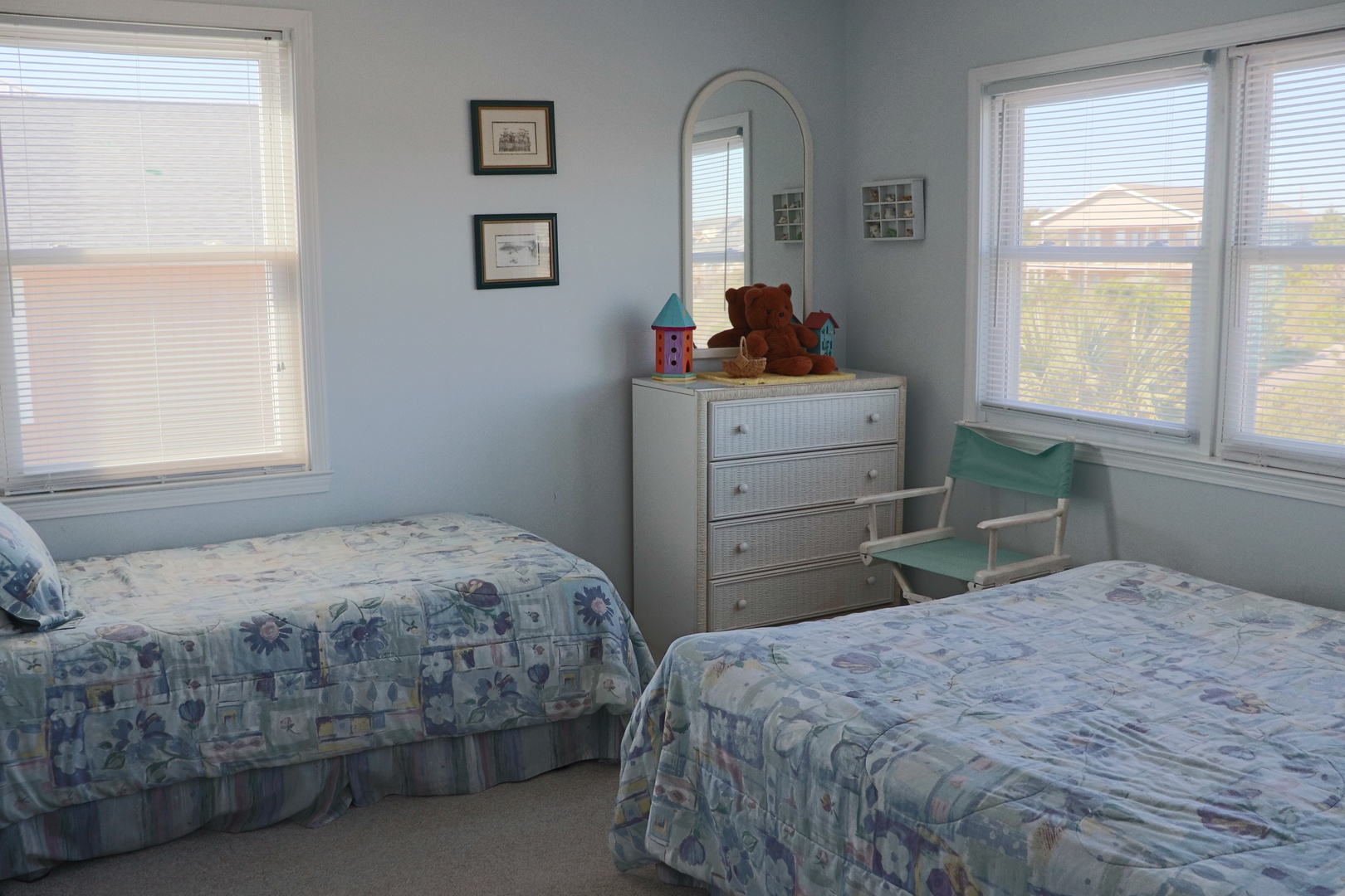 Your bright, cheerful bedroom features twin beds with charming blue floral quilts, perfect for a restful night's sleep.