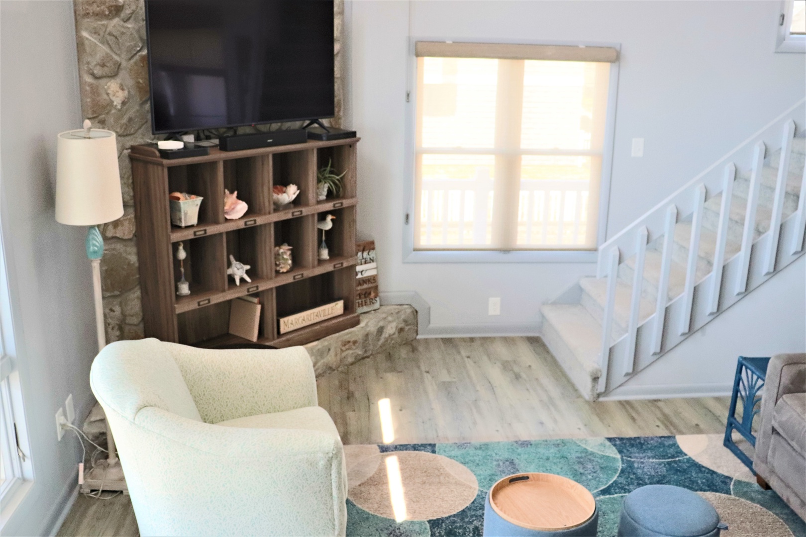 Relax in your bright, cozy living space with thoughtful touches, comfortable seating, and warm natural light streaming through your window.