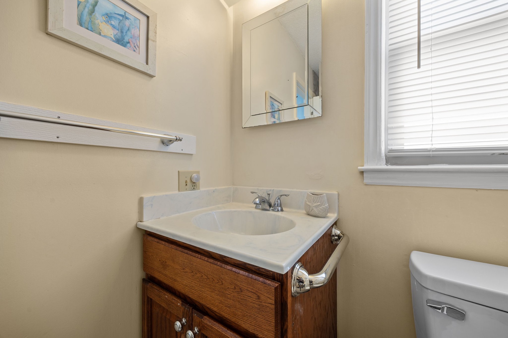 Your private bathroom features a classic vanity with marble countertop, perfect for your morning routine with natural light streaming in.