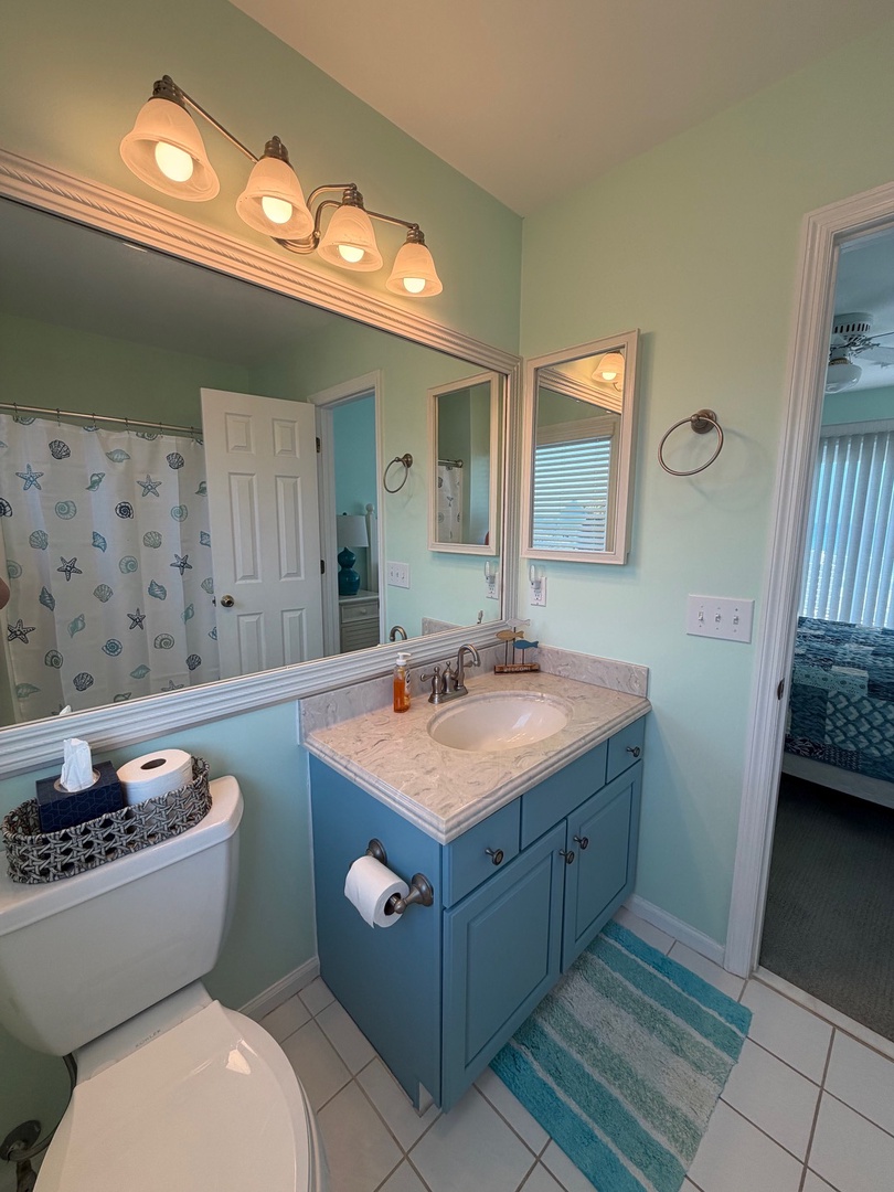 Refresh in your beautifully designed coastal bathroom with elegant vanity lighting, marble countertops, and soothing ocean-inspired tones.
