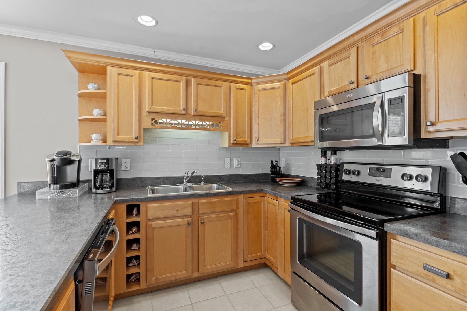 Cook to your heart's content in this fully equipped kitchen with granite counters, stainless appliances, and warm wood cabinetry.