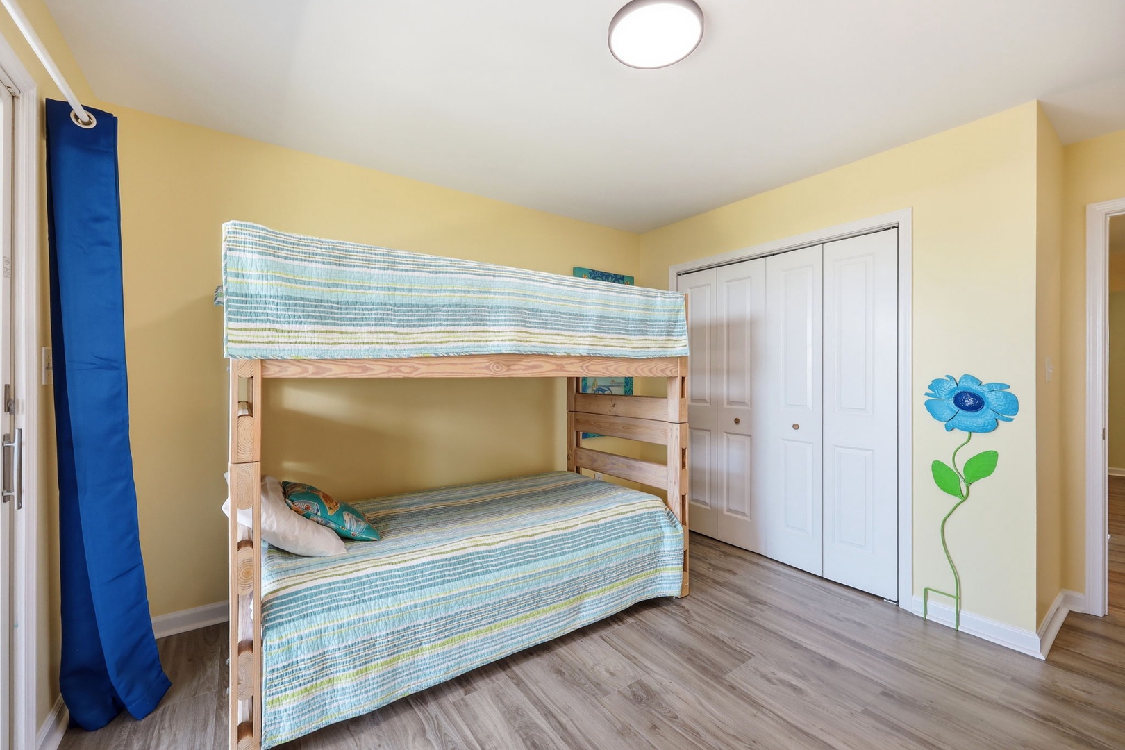 Cheerful bunk beds perfect for kids or extra guests, with beach-inspired bedding and playful wall art to make everyone feel right at home.