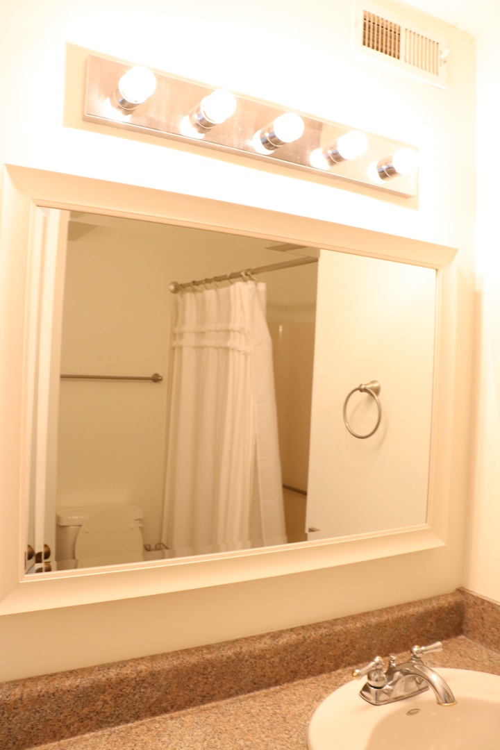 Step into your spacious, well-appointed bathroom with modern fixtures and fresh towels waiting for your arrival.