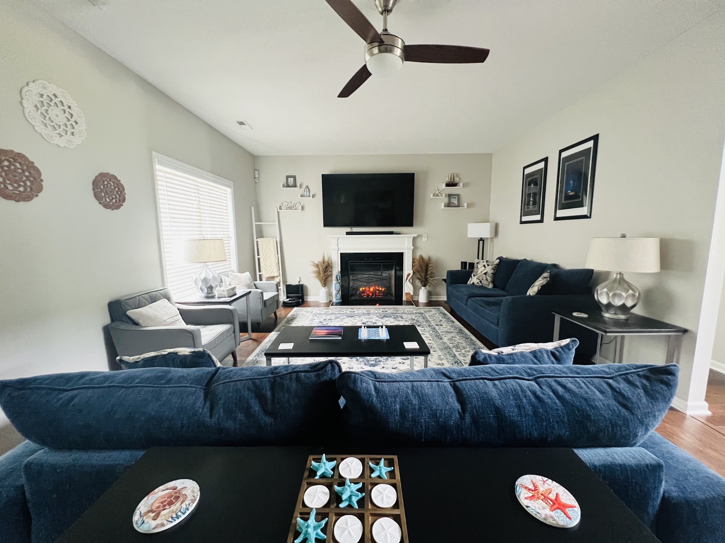 Sink into plush navy sofas by the crackling fireplace while your ceiling fan keeps you cool and the TV awaits your movie night.