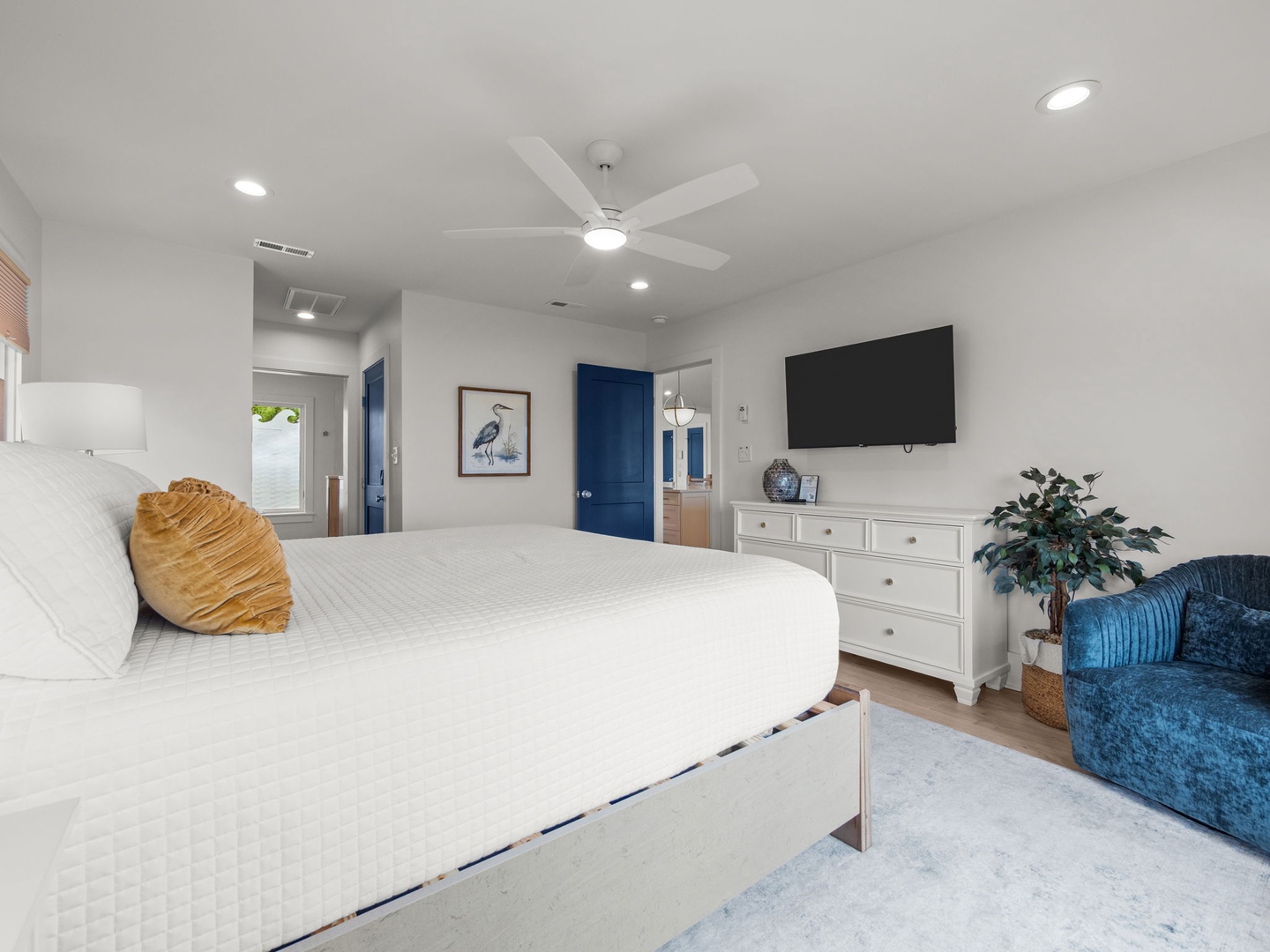 Unwind in your serene bedroom featuring a plush king bed, cozy seating nook, and modern amenities for the perfect night's rest.