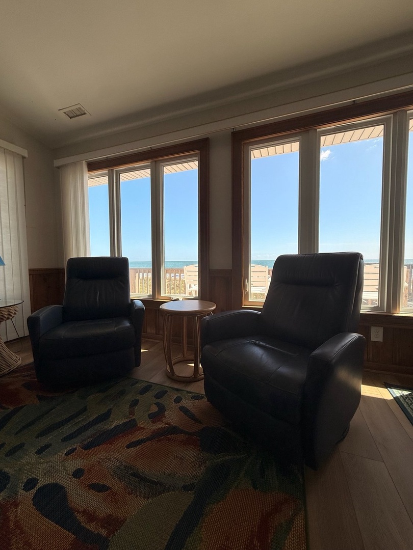 Sink into plush recliners and soak in direct beach views through floor-to-ceiling windows—your morning coffee or sunset watch just got infinitely better.