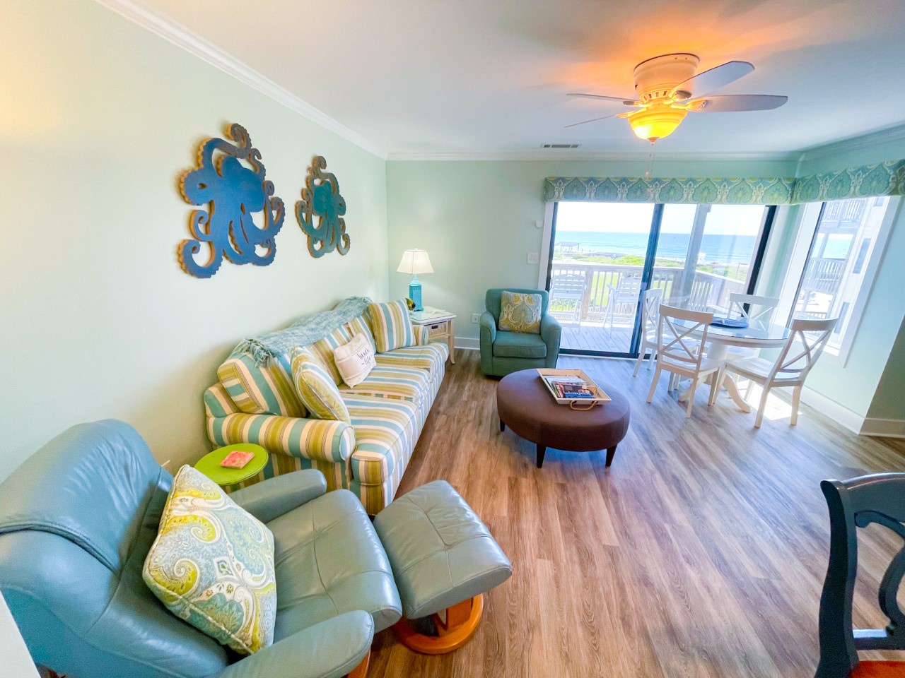 You'll love the cheerful coastal vibes in your bright living space, where playful octopus art and ocean-inspired decor create the perfect beach getaway atmosphere.