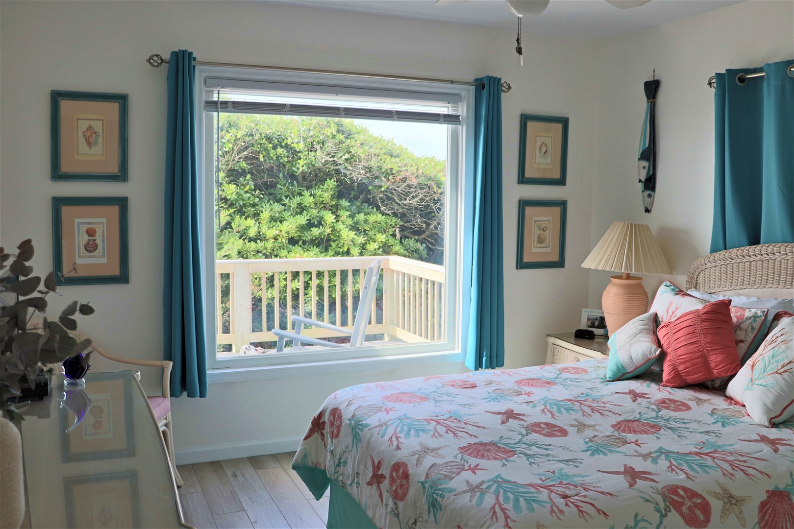 Wake up to your private balcony with lush garden views in this charming coastal bedroom designed for peaceful mornings.
