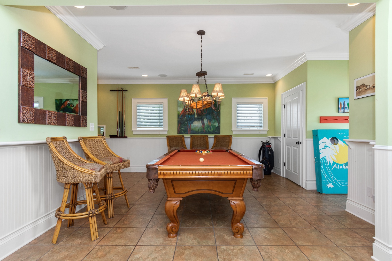 Challenge friends to pool while enjoying tropical island vibes in your private game room with stylish seating and island artwork.
