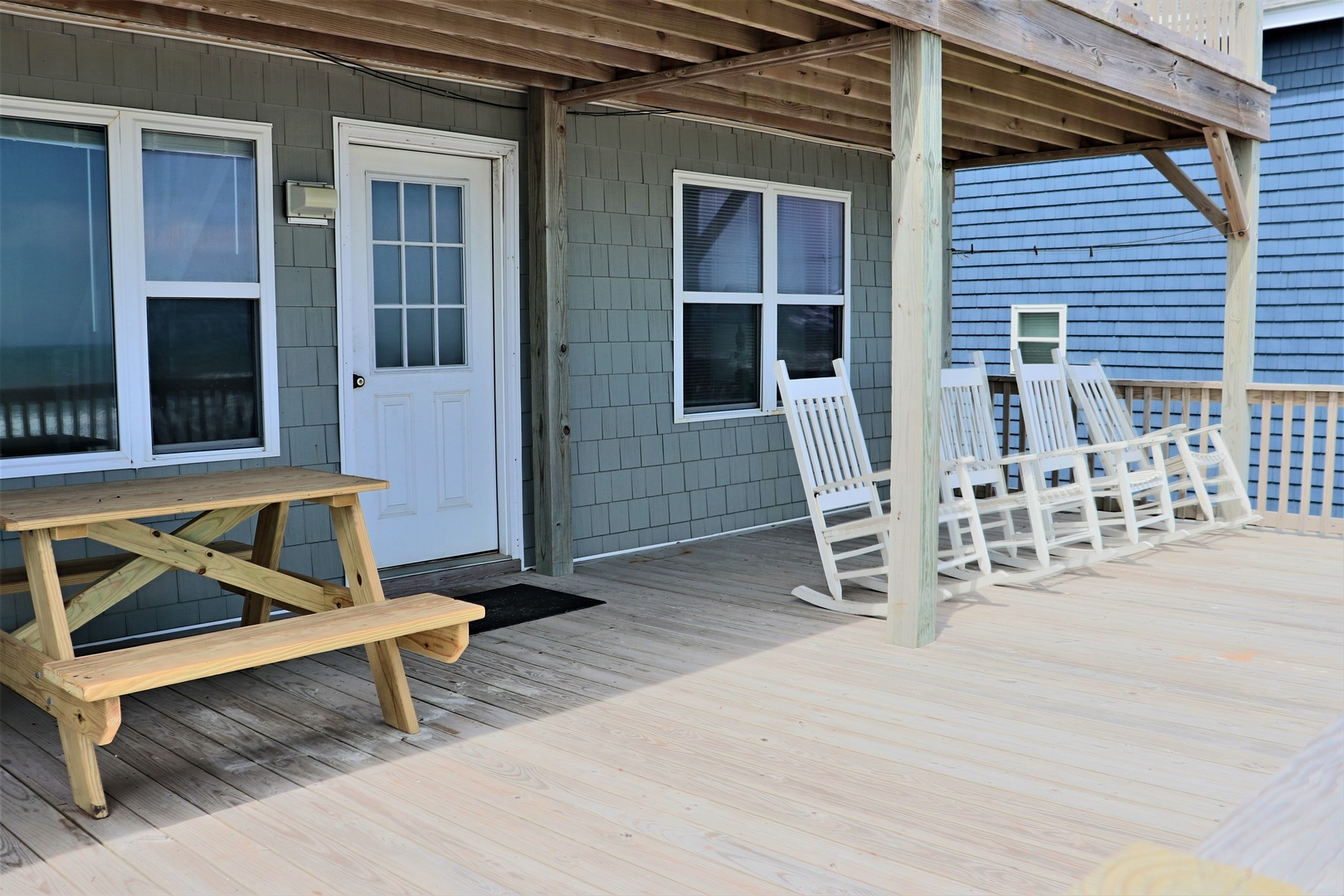 Relax on your private covered deck with rocking chairs and picnic table, perfect for morning coffee or evening conversations.