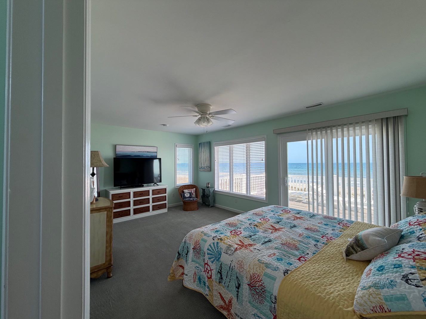 Wake up to stunning ocean views from your bright bedroom, where morning sunlight dances across the waves through floor-to-ceiling windows.