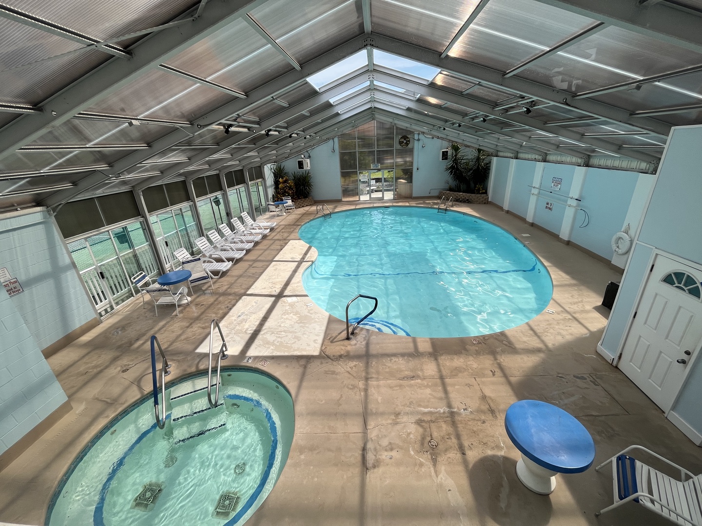 Dive into your private indoor oasis! This enclosed pool area lets you swim year-round in crystal-clear waters, with a relaxing hot tub nearby.