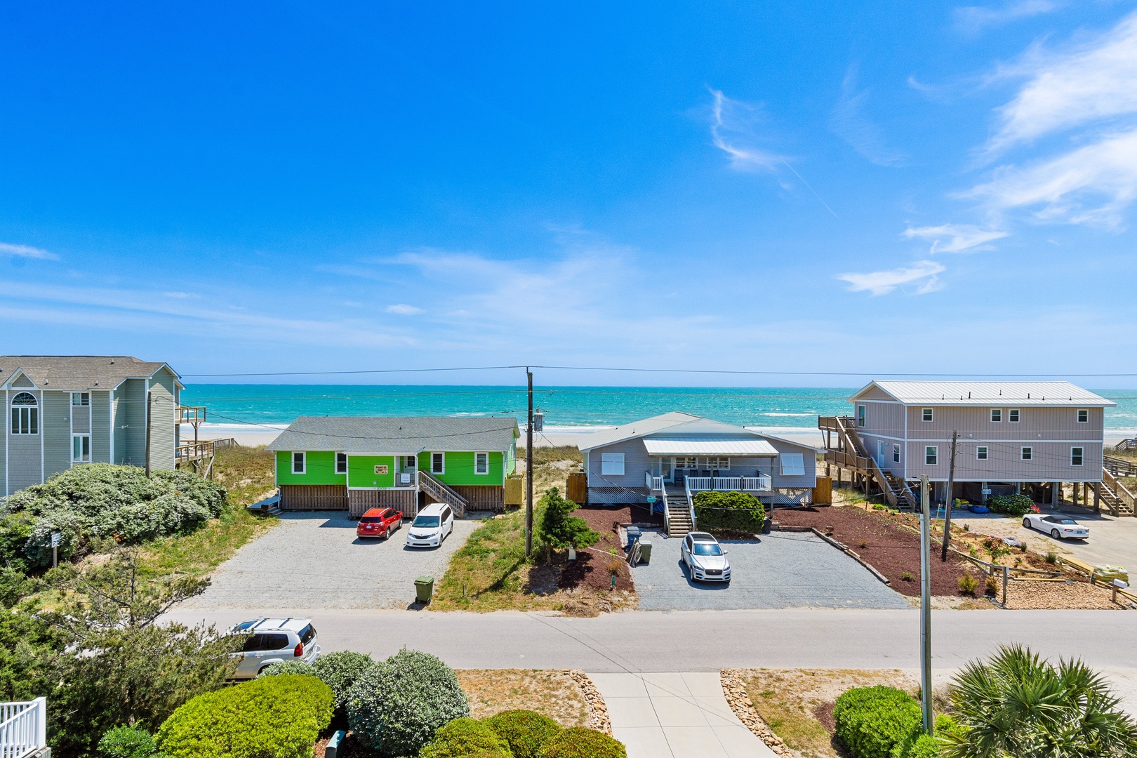 Beachfront vacation homes with convenient parking, just steps from the pristine turquoise waters and sandy shore.