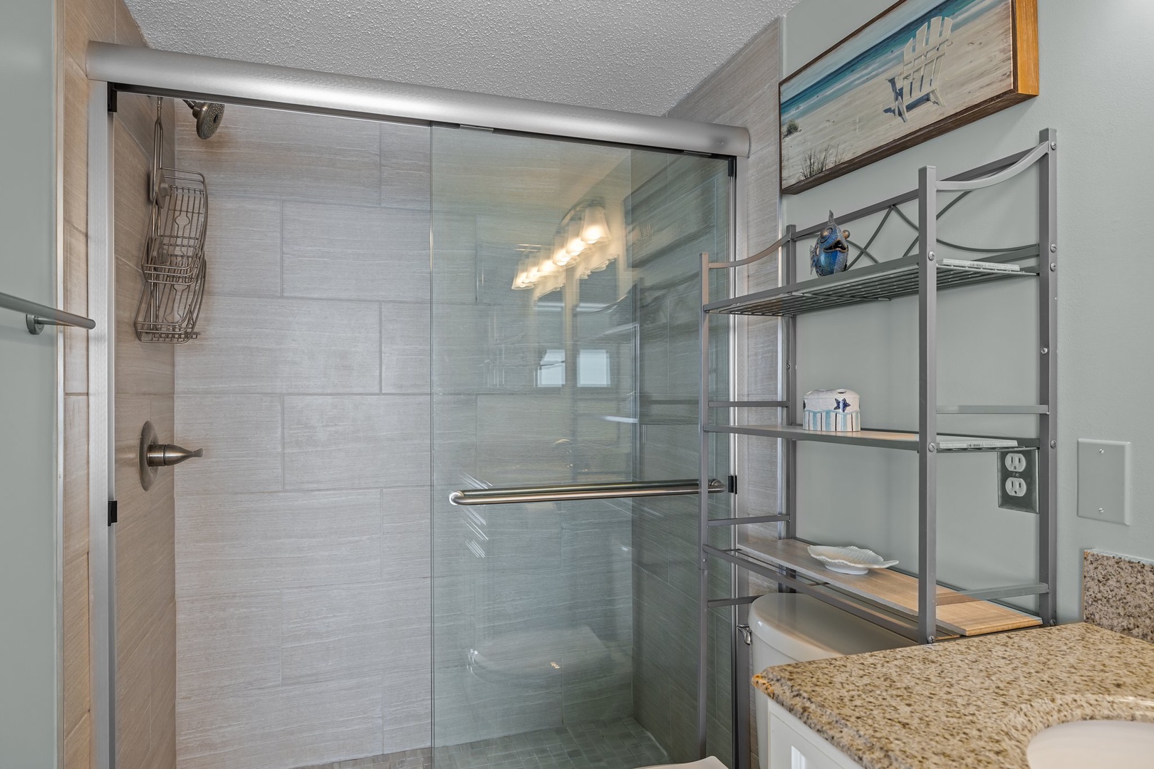 Step into your sleek modern bathroom with a spacious glass-enclosed shower and thoughtfully organized storage shelving.