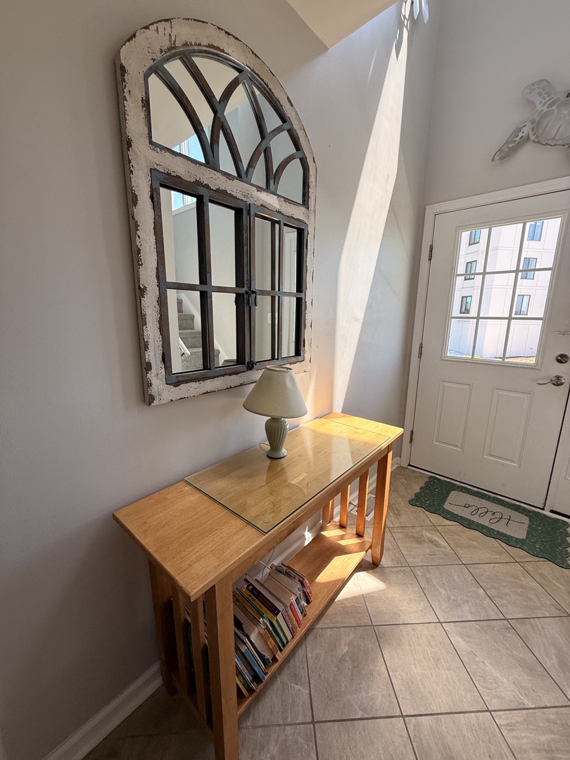 Bright skylight bathes this cozy reading nook in natural light, where you can curl up with a favorite book from the shelf and enjoy peaceful moments on your stay.