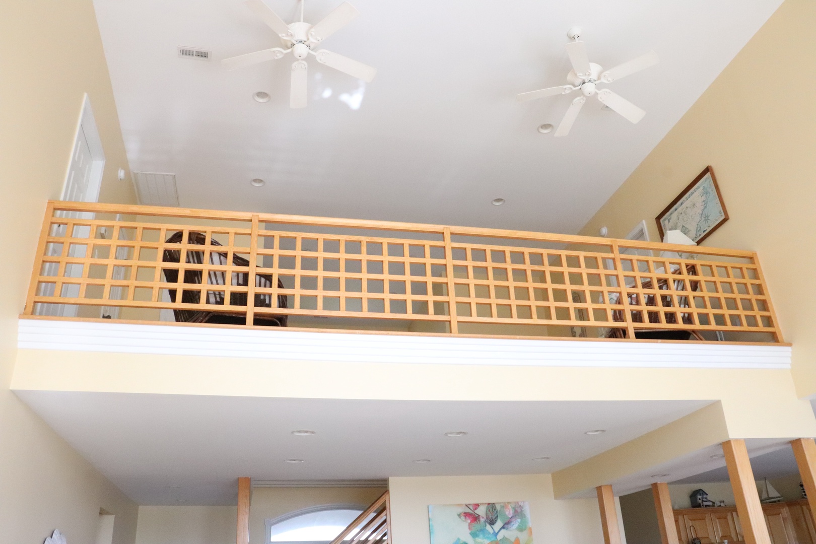 Look up to discover your private loft space with cozy seating and books, perfect for quiet moments away from it all.