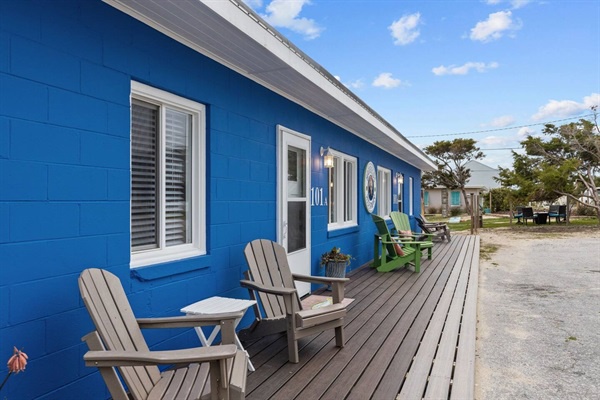 Your bright blue cottage features a private deck with Adirondack chairs, perfect for morning coffee and island breezes.