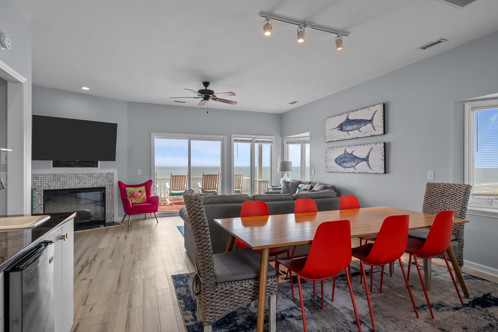 Gather with loved ones in this open living space where modern comfort meets coastal charm. Your ocean view awaits just beyond those doors.