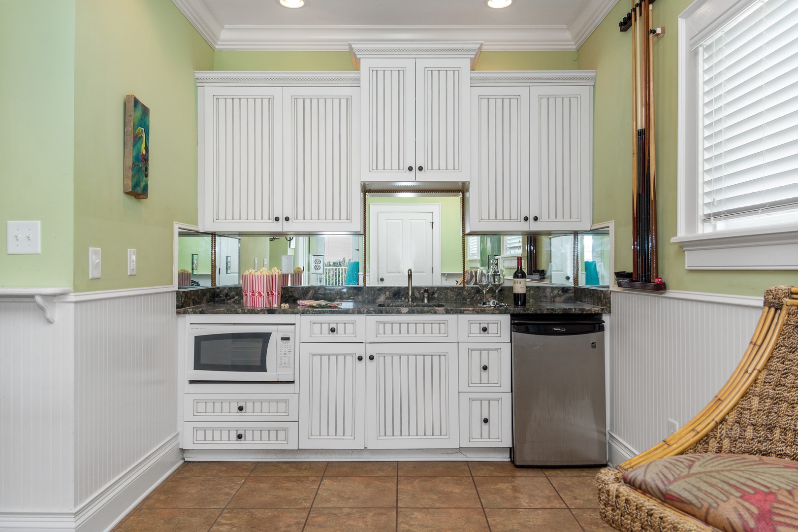 Your fully equipped kitchen features crisp white cabinets, granite countertops, and stainless appliances—perfect for preparing meals during your stay.