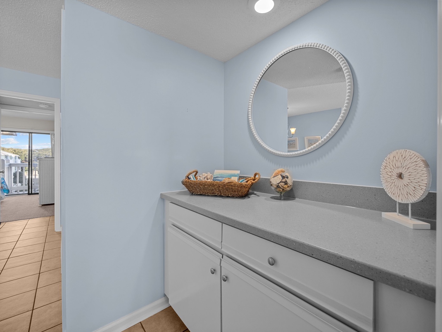 Your bright powder room features coastal-inspired decor and ample counter space for your daily routines.