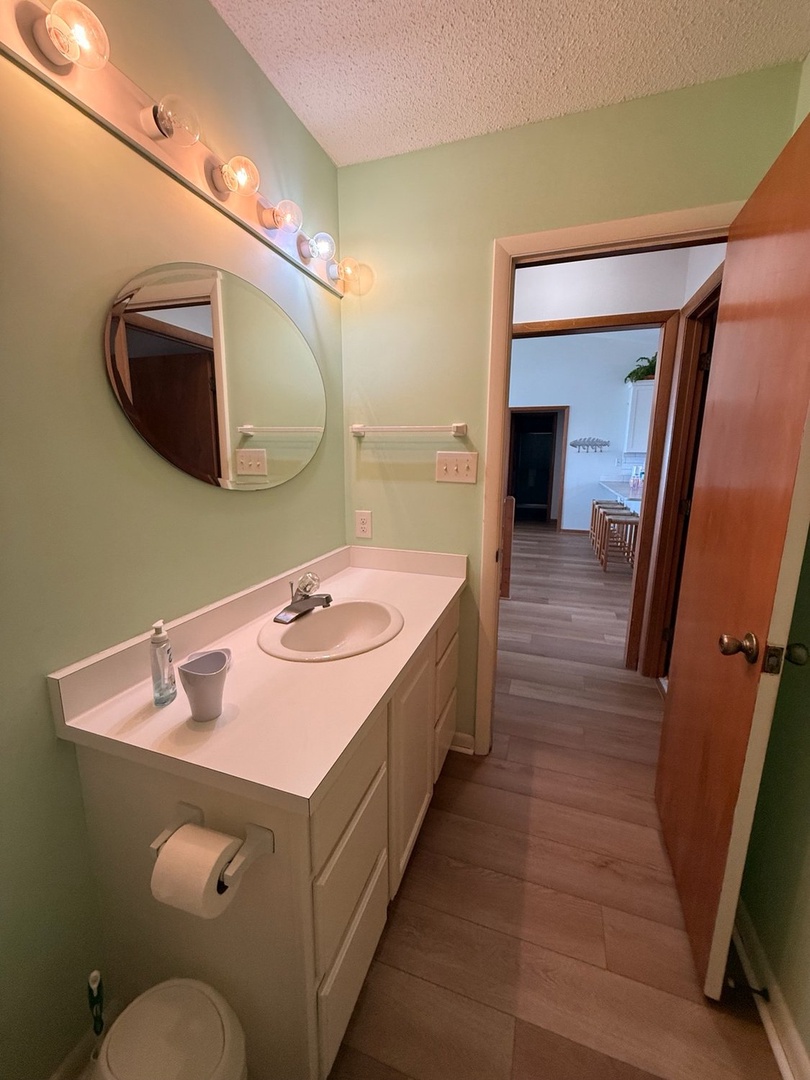 Freshen up in your light-filled bathroom with soft green walls and plenty of vanity space to get ready for your day.