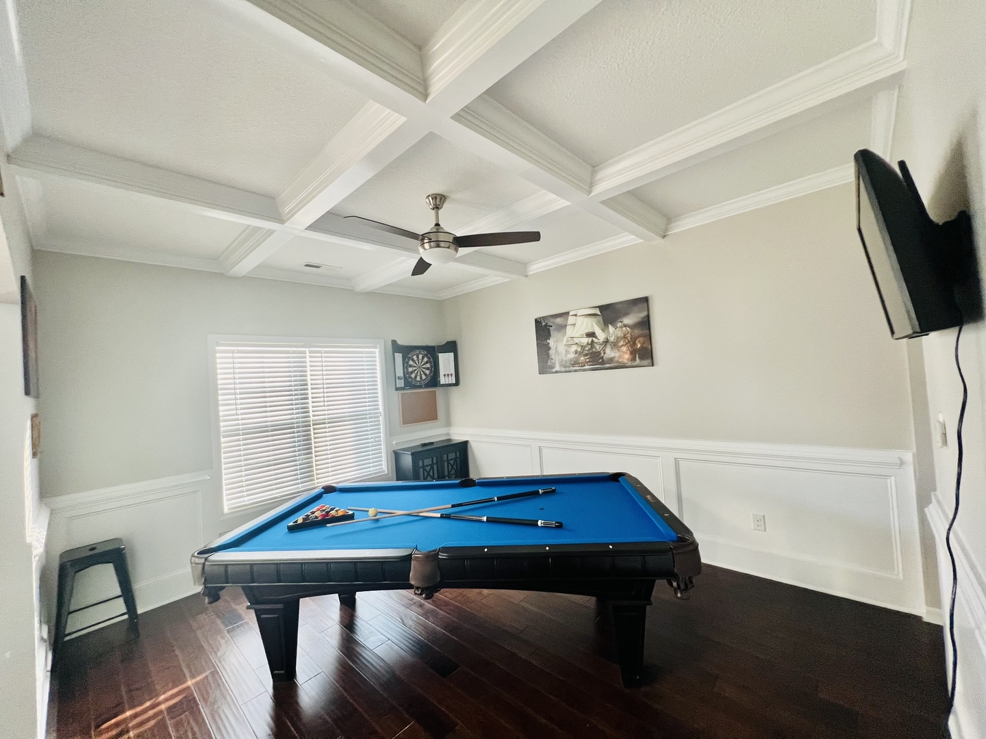 Challenge your friends to a game in this elegant entertainment room featuring a regulation pool table beneath stunning coffered ceilings.