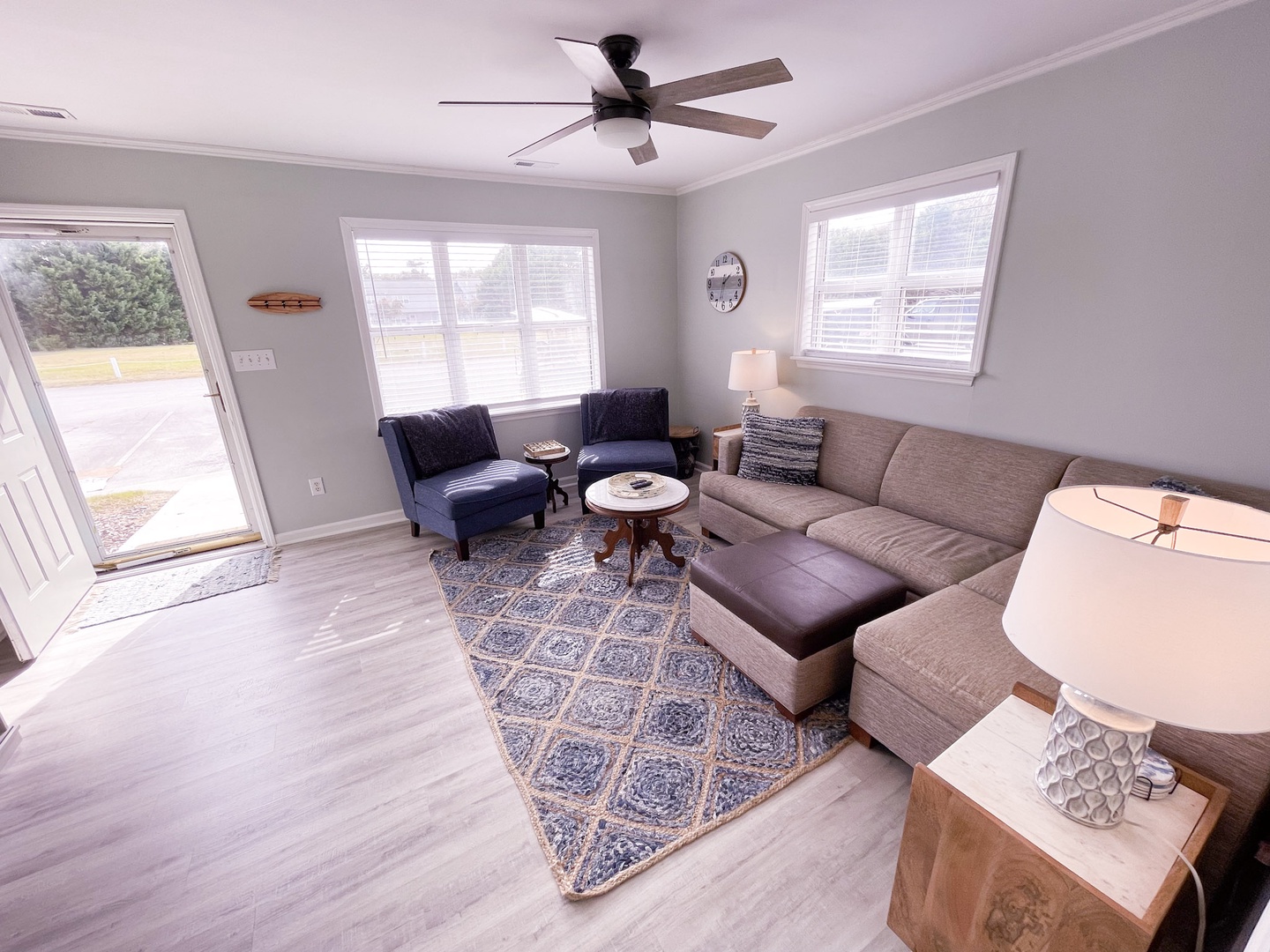 Relax in your bright, airy living room with plush seating and charming coastal touches that create the perfect space for gathering.