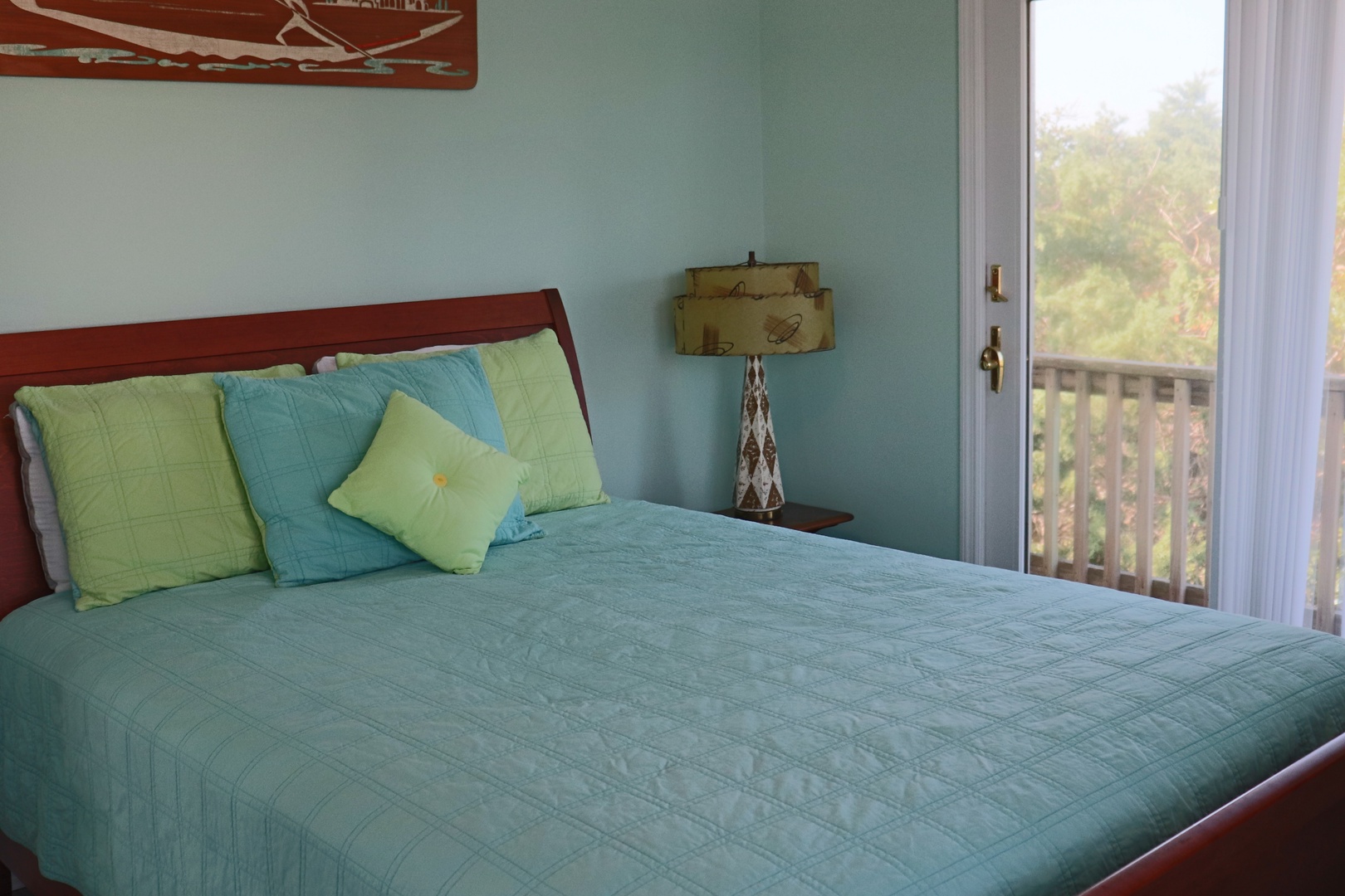 Unwind in your serene coastal bedroom with crisp linens, soothing sea-glass colors, and private balcony overlooking lush greenery.
