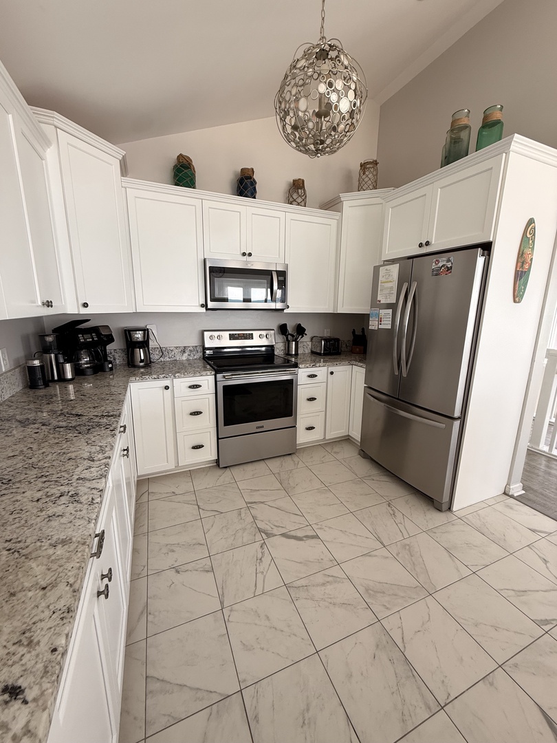 Your fully-equipped kitchen blends modern convenience with elegant design, featuring stainless steel appliances, granite countertops, and ample storage—perfect for preparing memorable meals during your stay.