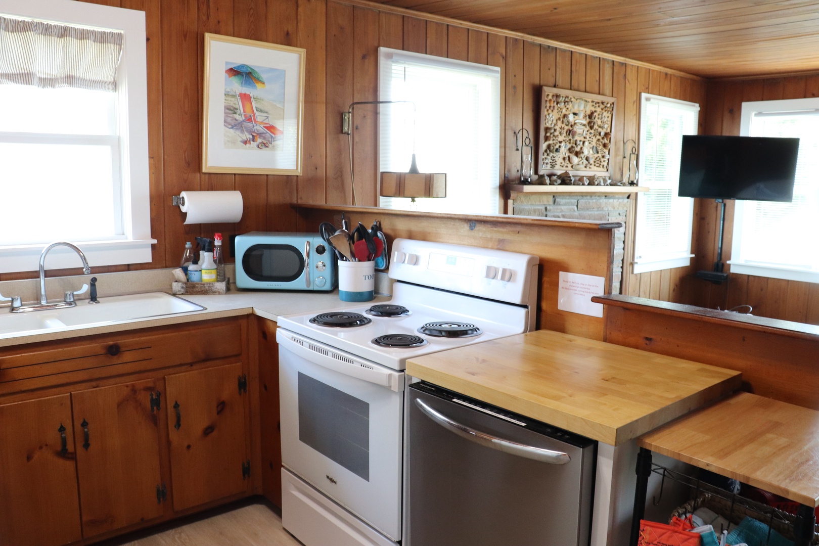 Prepare delicious meals in your fully equipped kitchen with warm wood paneling and modern appliances.