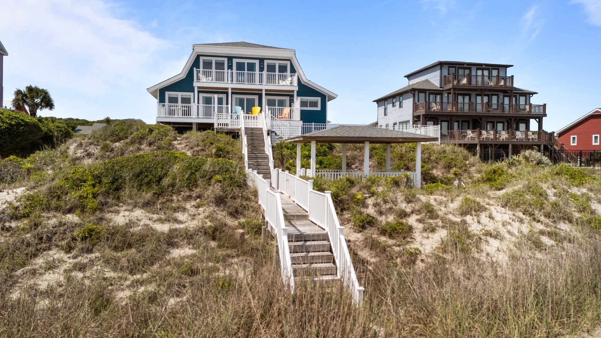 Charming beachfront homes with elevated boardwalks offer stunning coastal access and panoramic ocean views in this peaceful seaside community.