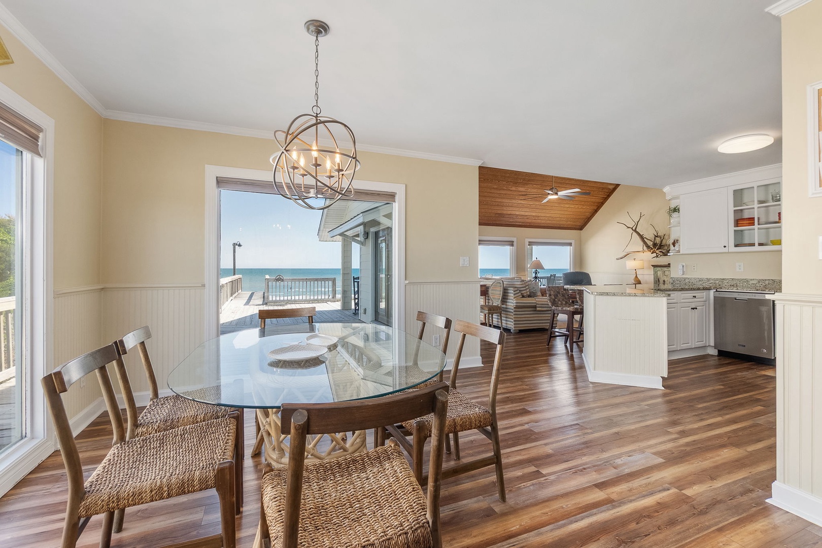 Gather around your elegant dining table with stunning ocean views flowing seamlessly into your bright, open-concept kitchen.