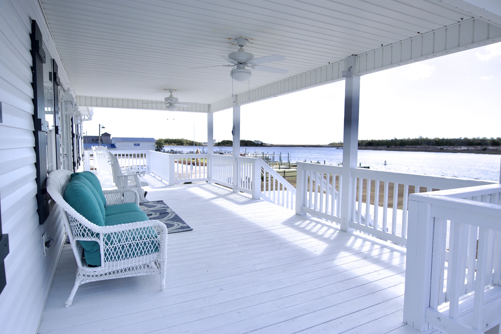 Relax in your private waterfront retreat with cushioned wicker seating overlooking the marina's peaceful waters.
