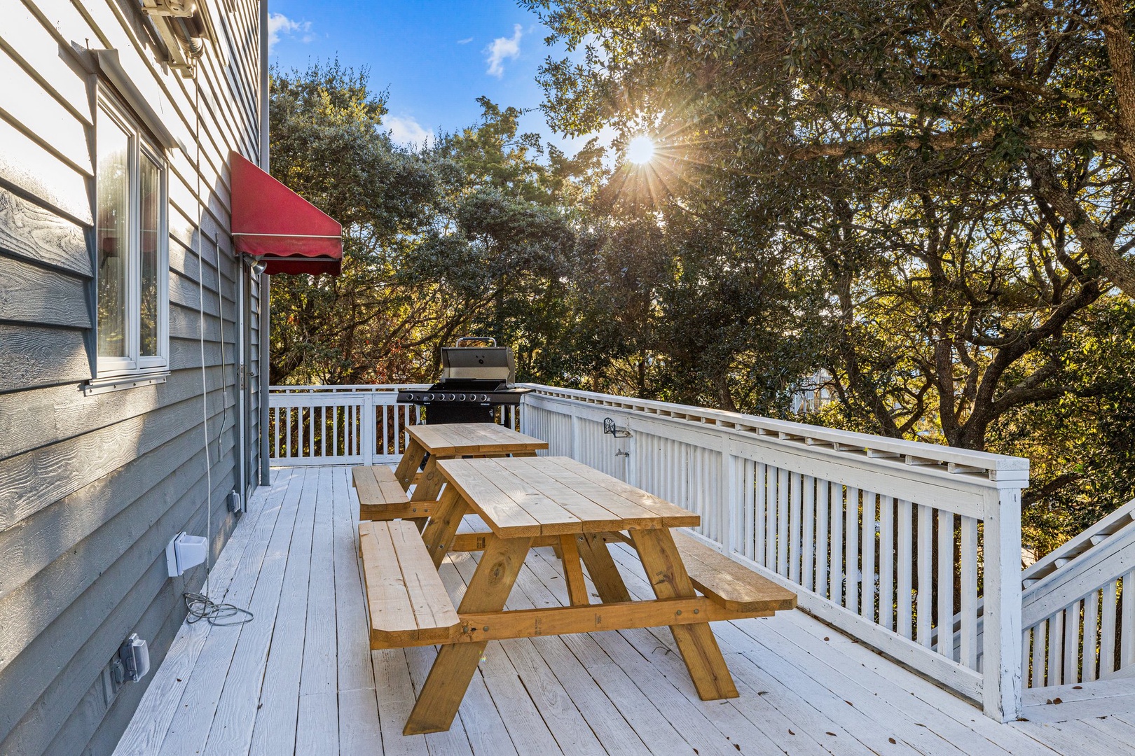 Step onto your private deck where morning coffee meets golden sunlight filtering through mature trees, creating the perfect backdrop for outdoor dining.