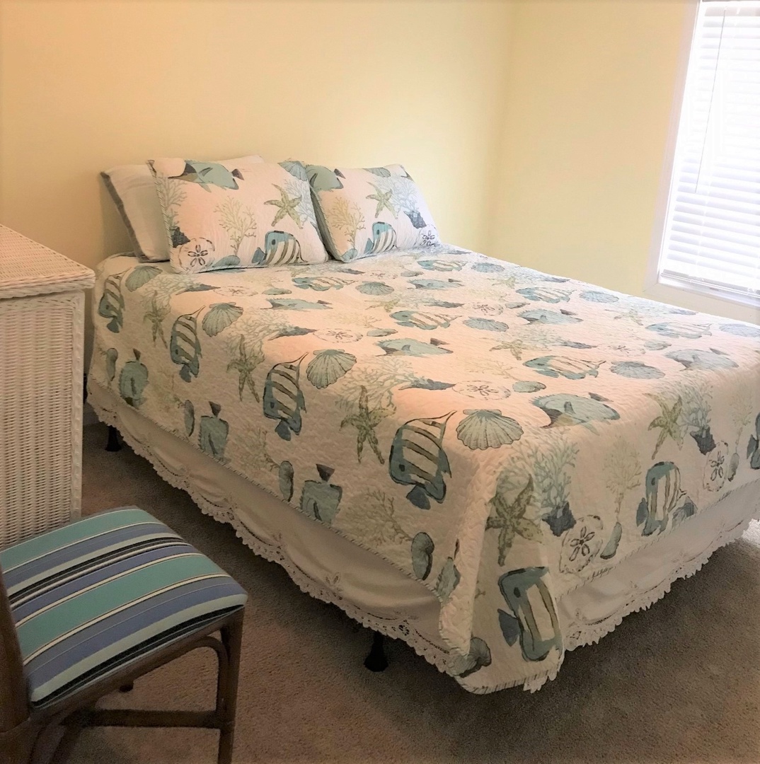 Drift off to sleep surrounded by charming ocean-themed bedding featuring seashells and coral in your cozy bedroom retreat.