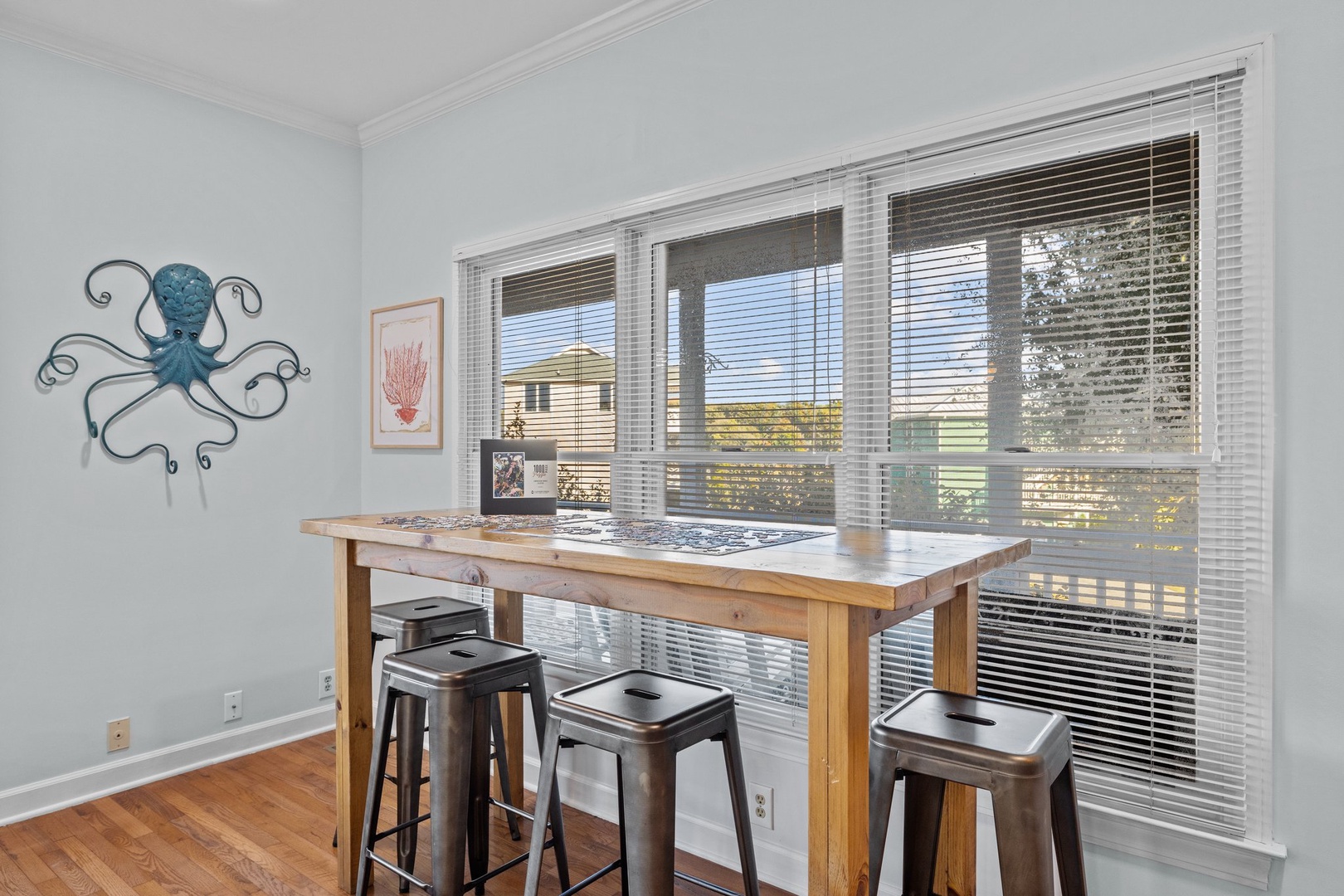 Gather around your perfect breakfast nook, where morning coffee and evening games happen at your cozy high-top table bathed in natural light.