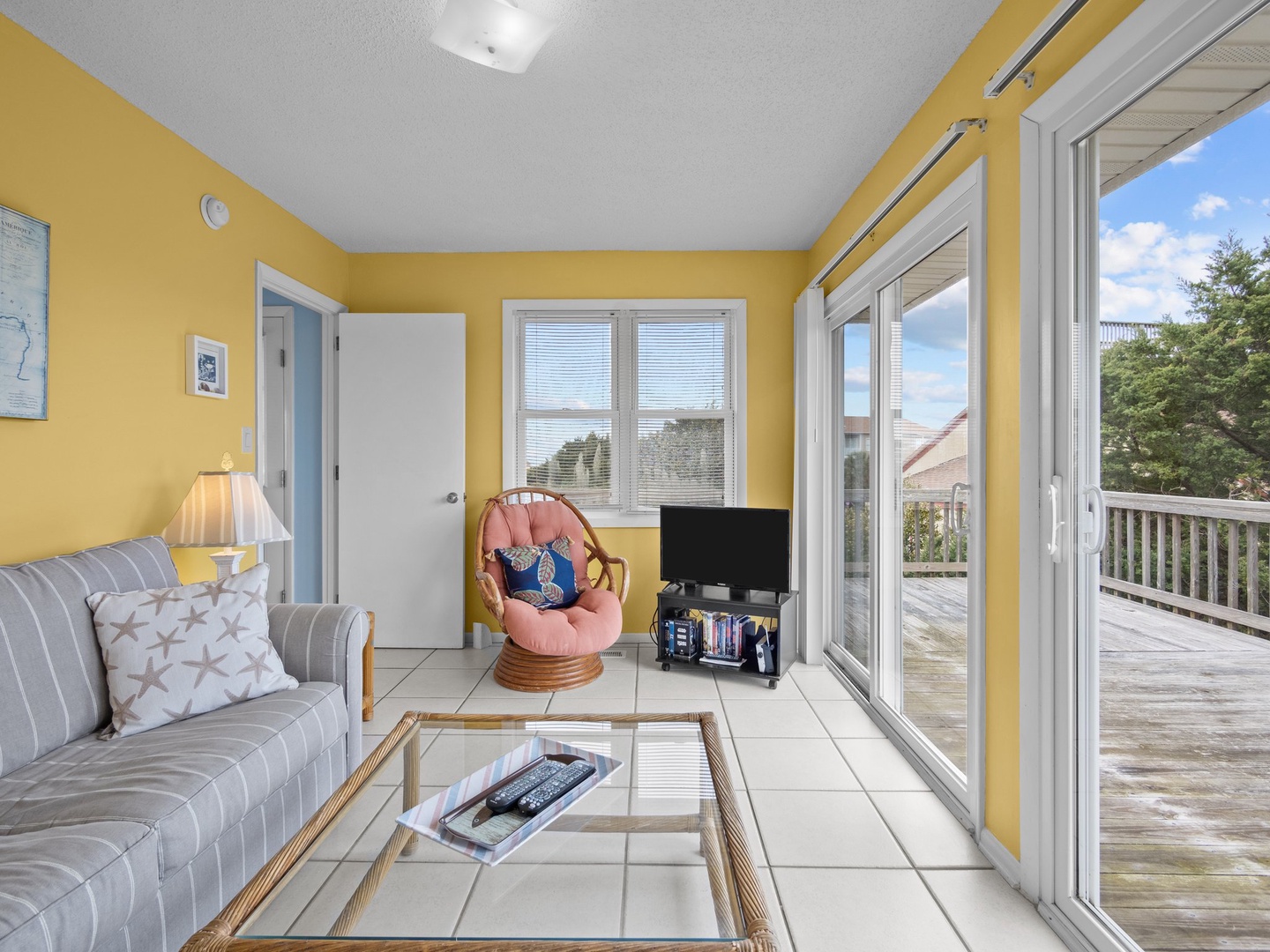 Unwind in your sunny living room with cheerful yellow walls and glass doors opening to your private deck.