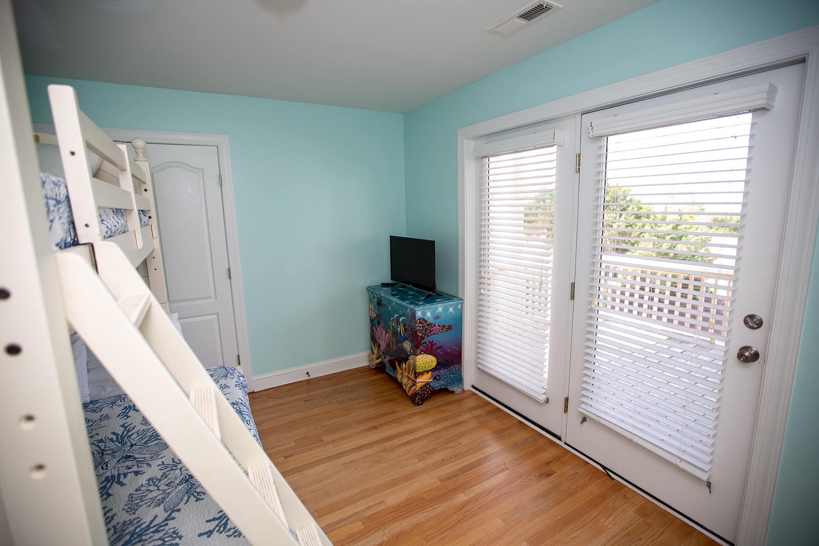 Your kids will love this ocean-themed bunk room with private deck access and their own TV for movie nights.