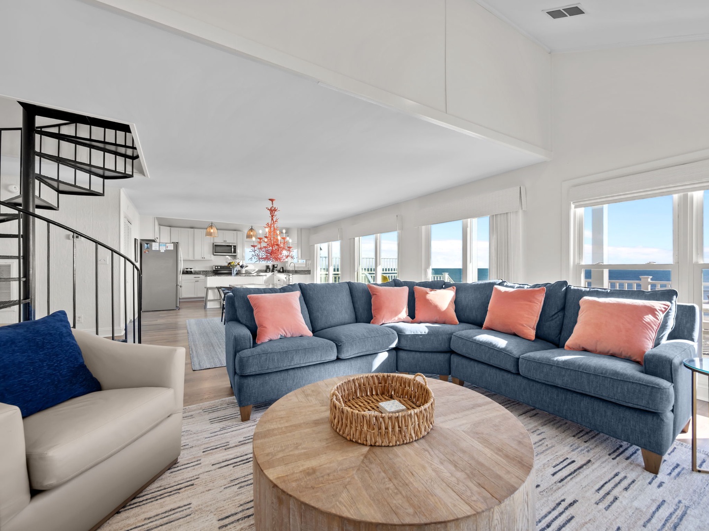Sink into this plush sectional sofa while ocean views fill your windows. The open-concept design flows seamlessly to your modern kitchen.