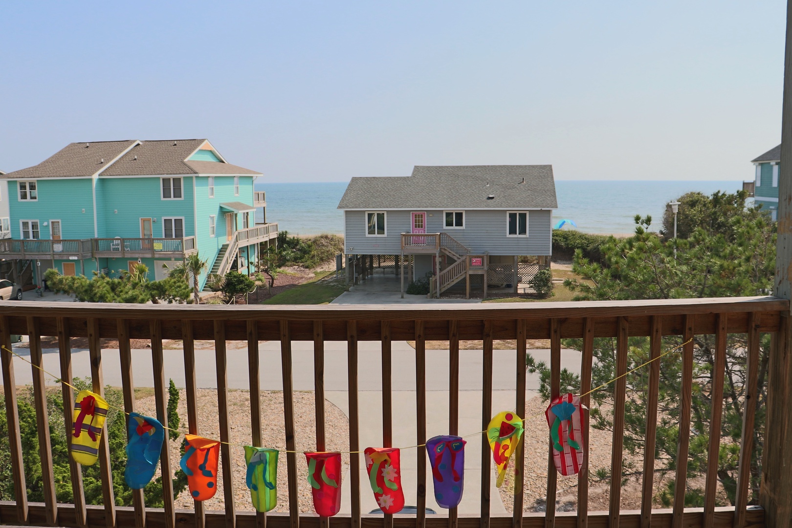 Wake up to colorful beach towels drying in the ocean breeze while you sip morning coffee overlooking sandy shores.