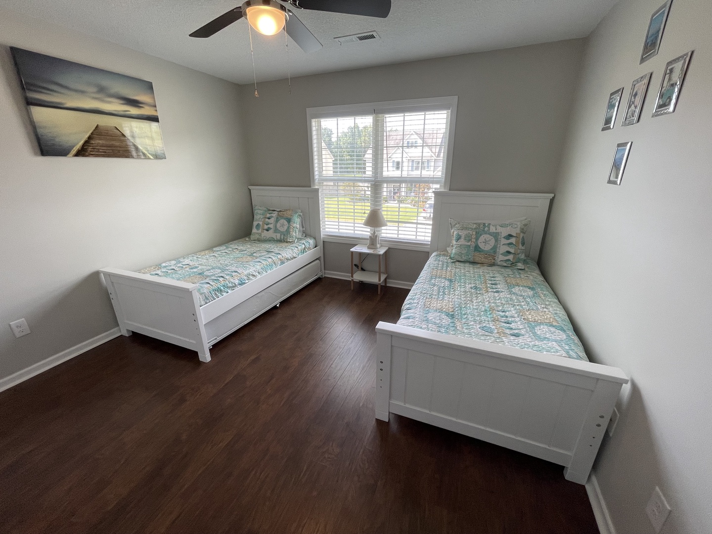 Wake up refreshed in this peaceful twin bedroom featuring comfortable beds and coastal artwork that sets the perfect tone for your getaway.