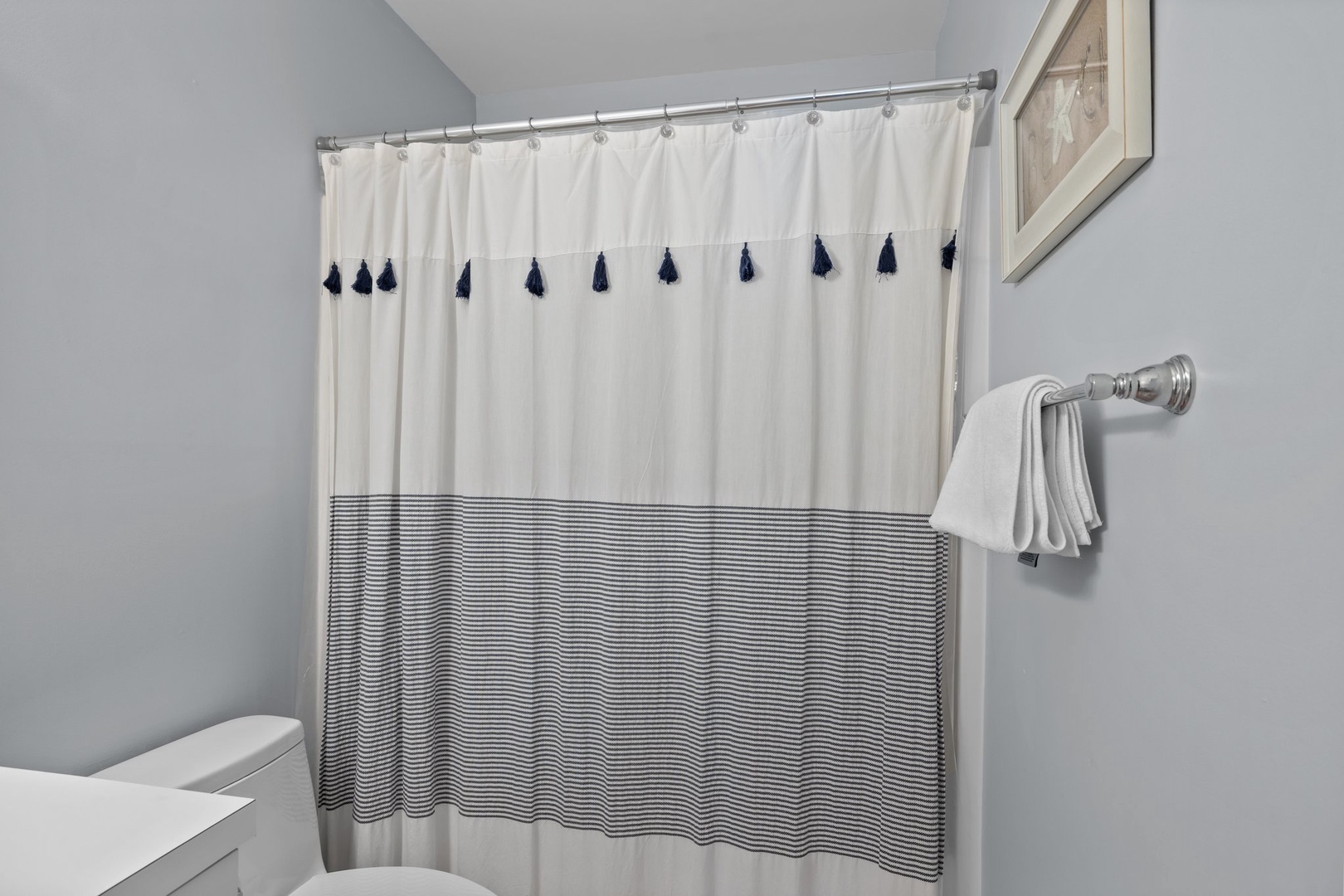 Step into your private bathroom with crisp linens and thoughtful nautical touches that make freshening up feel like a spa retreat.