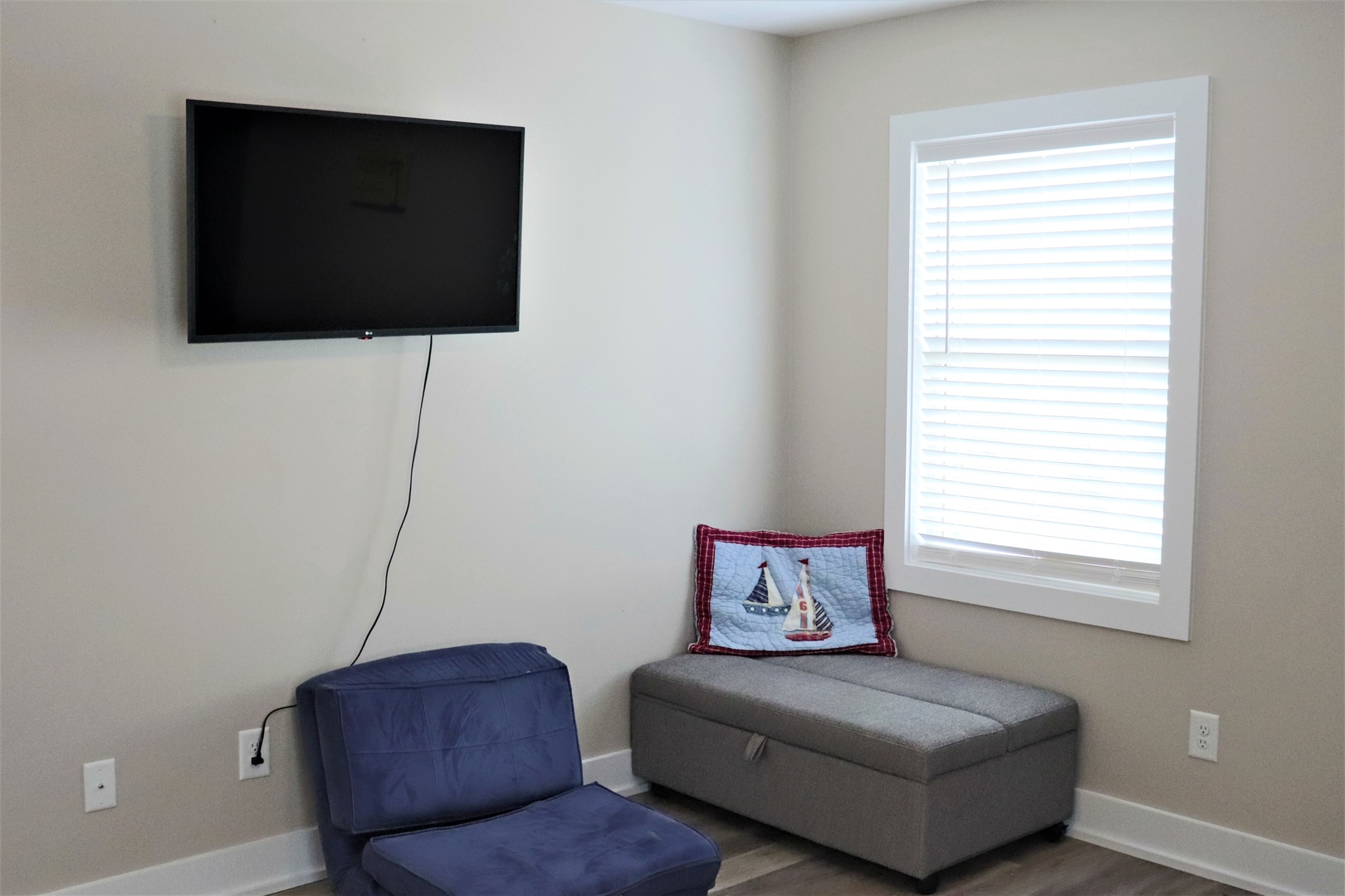 Relax in your comfortable seating area with a large flat-screen TV for your evening entertainment and natural light from the window.