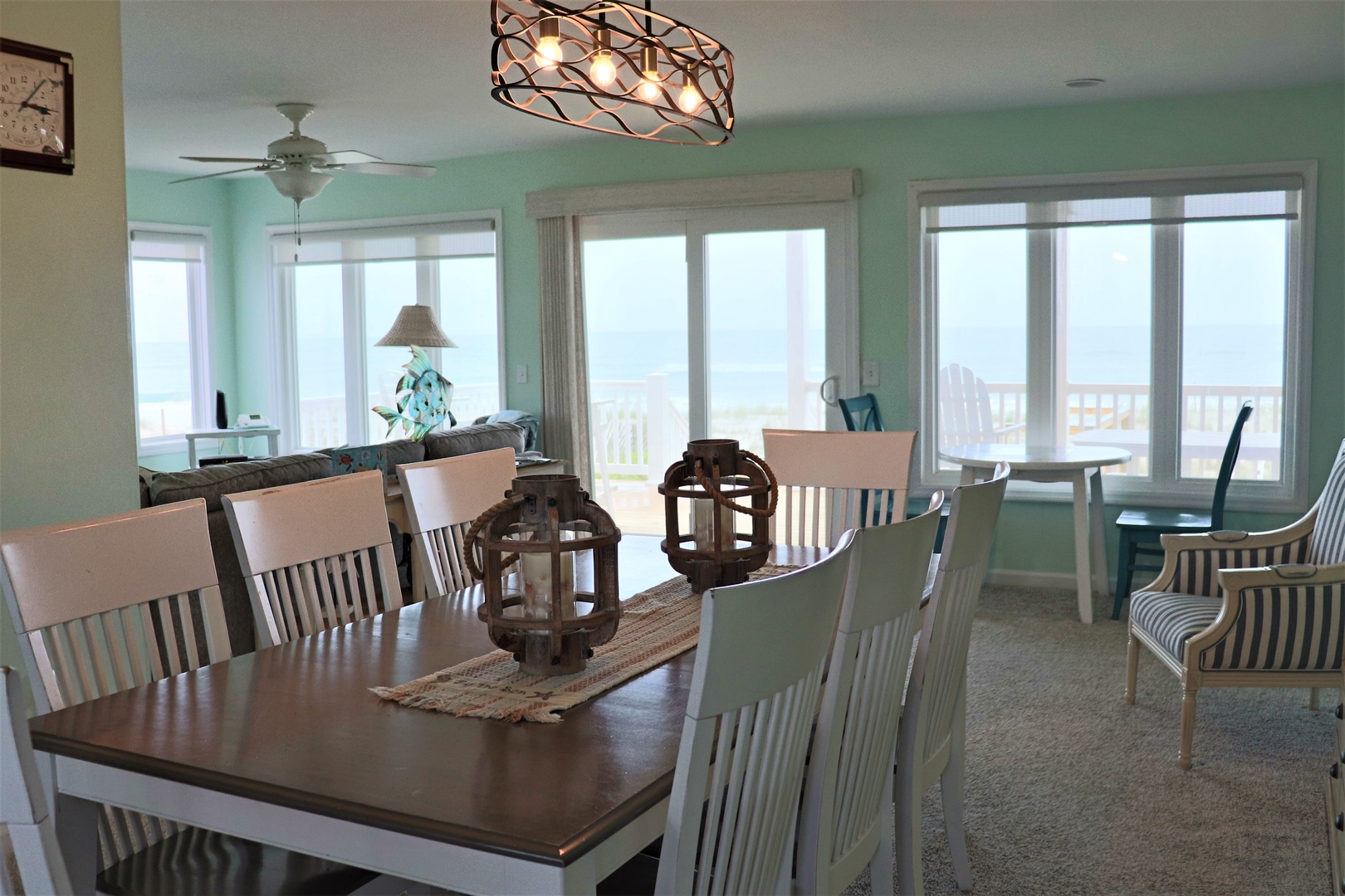 Gather around this spacious dining table for memorable meals with stunning ocean views through floor-to-ceiling windows.