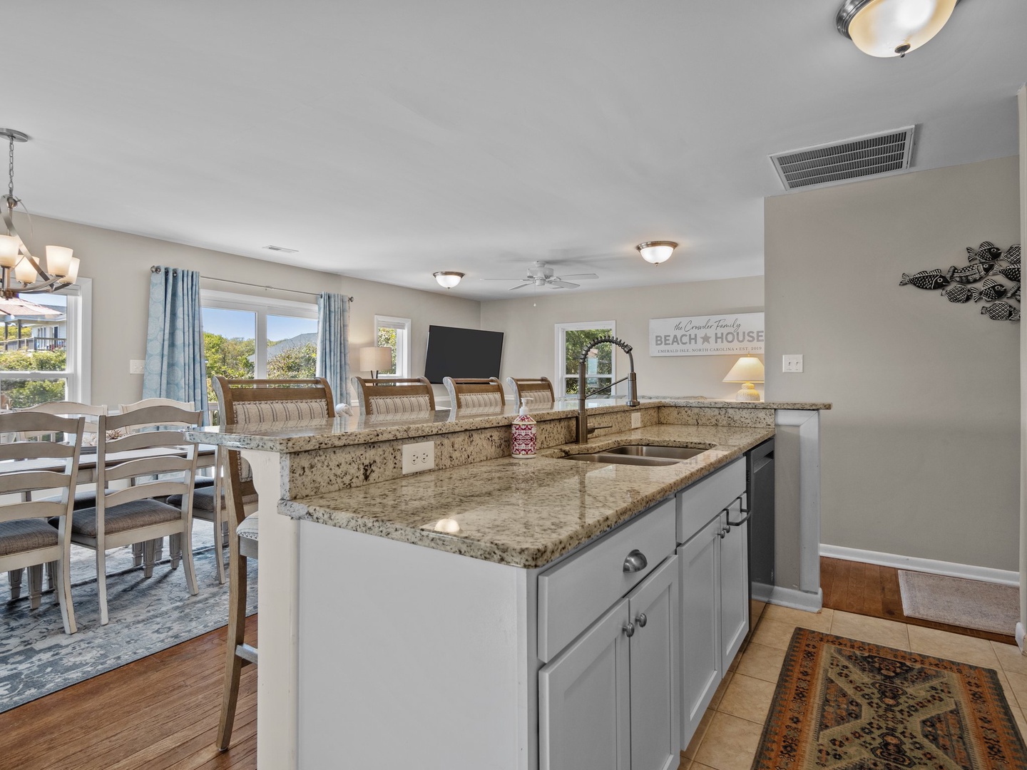 Cook and socialize in this bright, spacious kitchen featuring granite counters, modern appliances, and an open flow to the dining area.